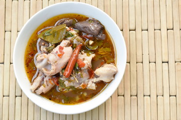 boiled chicken bone with herb and tamarind leaf Thai spicy soup on bowl