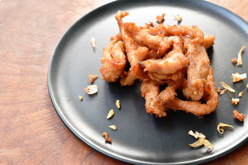 fried slice salty pork with crispy garlic on plate