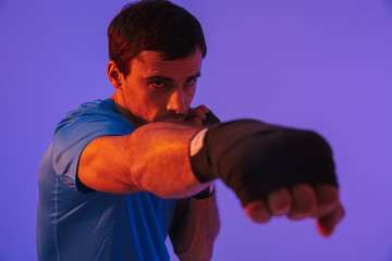 Portrait of a fit confident sportsman doing boxing