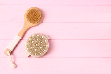 brush for dry massage on a colored background top view.