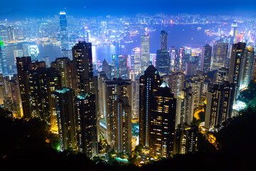 The most famous view of Hong Kong at twilight sunset. Hong Kong skyscrapers skyline cityscape view from Victoria Peak illuminated in the evening. Hong Kong, special administrative region in China.