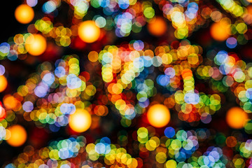 Christmas tree blurred. blurred background of Christmas lights. A new year tree decorated with lanterns is blurred in bokeh. blue and yellow bokeh © Stanislav