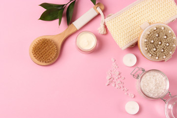 Brush for massage in the spa composition on a colored background top view. Prevention of cellulite skin care. Flatlay