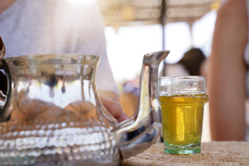 Closeup of glass of moroccan mint tea set on table