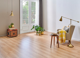 Modern room for carpet on the brown parquet, gold vase of flower lamp and picture, windows and white wall.