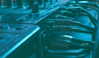 Night club concept. Audio mixer with wires close up. Duotone effect