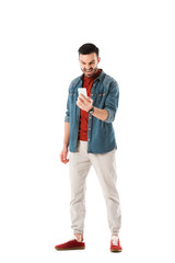 irritated man in denim shirt using smartphone isolated on white