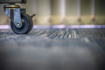 Small black rubber wheels on the carpet.