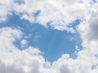 white cloud with a hole in the sky