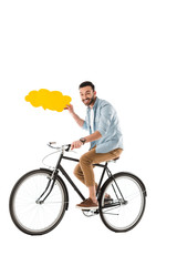 Obraz premium cheerful man riding bicycle while holding thought bubble isolated on white