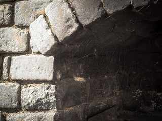 Stone oven.  Close up of Traditional stone oven. Grey stone texture. Spider web close up.
