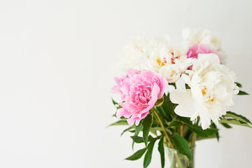Fototapeta na wymiar peonies in a vase on a white background