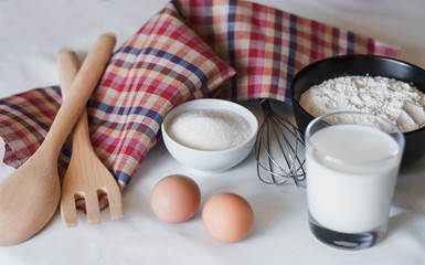 Ingredients for pancake. Flour, sugar, butter, eggs and milk on the table.
