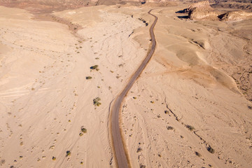 Old Desert road with cracked asphalt, Top down aerial image.