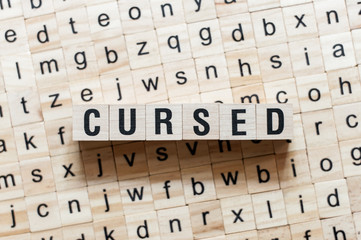 Obraz premium Cursed word concept on cubes