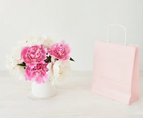 peonies in a vase on a white background
