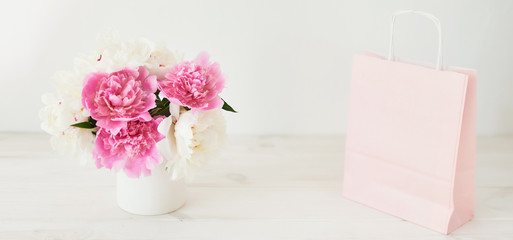 peonies in a vase on a white background