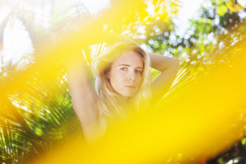 Young beautiful sensual girl on the background of a tropical garden, beauty and nature concept