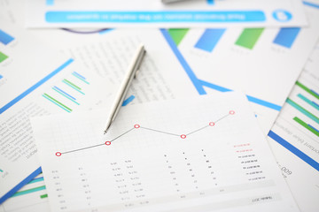 Silver pen lie on paper chart with