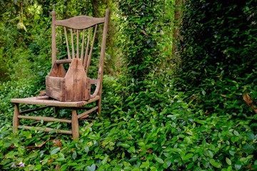 Naklejka premium Old wooden toolbox and chair in the garden