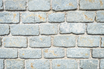 Stone wall. Stony blocks texture. Grey  stone rock wall. Wall of gray stones bonded with cement. 