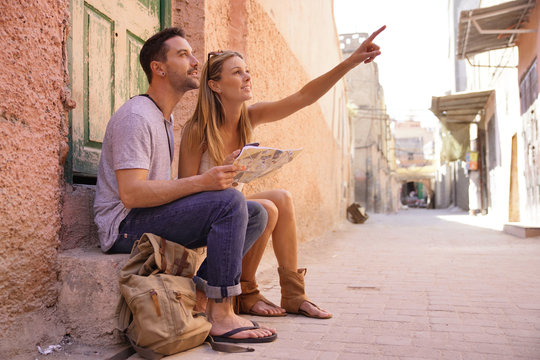 Couple of tourists looking at map of Marrakech