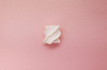 Creative colored pink marshmallows background. Flatley from the favorite dessert of children. Pop art motifs in photography.