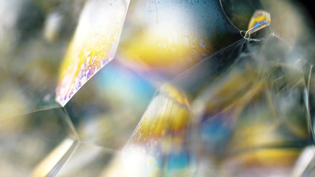Close up of soap bubbles with different color inside. Close up macro 4k footage.