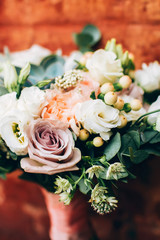 bouquet on the brick wall background. bouquet with peonies and succulents.