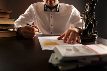 Closeup view of money and laywer concept on the desk. Male attorney behind
