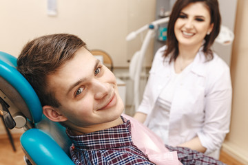 Dentist with male patient in the dental room