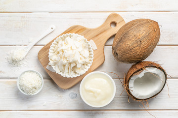 Wellness concept - coconut oil and ingredients on wood background, copy space