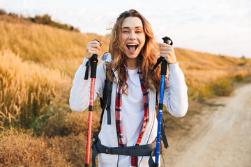 Happy young girlcarrying backpack