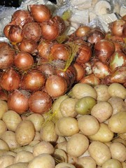 Sacks of onions and potatoes, displayed for sale in a market. Organic and healthy food.
