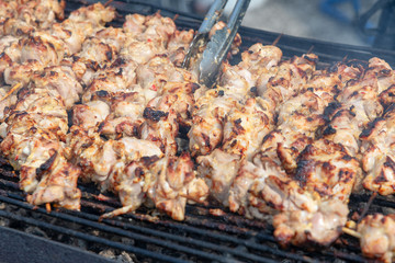 Cooking of meat on barbeque.