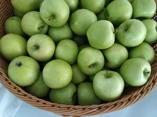 Granny smith apples in a wicker basket