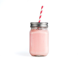 Pink strawberry smoothie in mason jar glass. Isolated on white with clipping path.