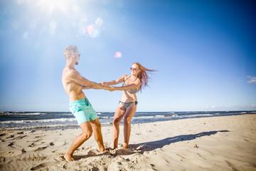 Young people on beach and summer time. Free space for your decoration. 