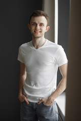 portrait of a young handsome guy in light room