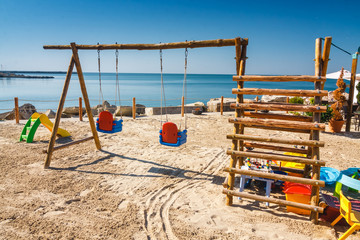 Fototapeta na wymiar playground for children on the beach at sunny day
