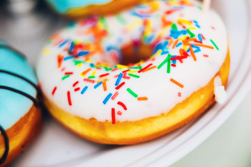 Glazed round donut with powder. blue and lilac donut.