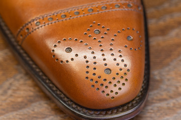 brown brogue toe of men full grain leather shoe, close up