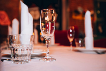 empty champagne glass and simple glass on banquet table
