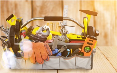 Gloves and tools on wooden background