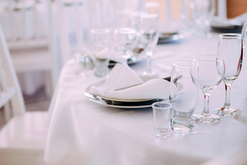four Empty champagne and wine glasses   on the white banquet table