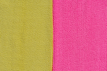 Two contrasting cloth textures. Pink and yellow neon textured fabric. Detailed closeup material. Copy space.