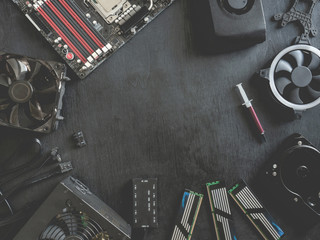 top view of computer parts with harddisk, ram, CPU, graphics card, and motherboard on black table...
