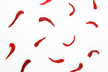 pods of red dried hot bitter edible pepper on a white background