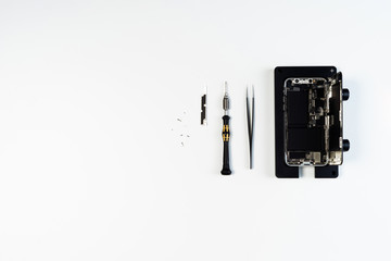 Disassembled Open Mobile Phone Screwdriver Tool Above Flat Lay Isolated on White Background. Dismantle Smartphone. Cellphone Holder Overhead. Telephone Fix Fix Service Overhead