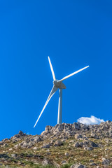 Fototapeta na wymiar View of a wind turbine on top of mountains